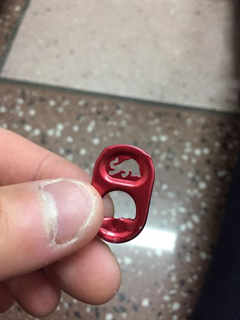 the red bull can tab has a bull on it. Soda Tab Fish Hook, Soda Tab Person, Tabs Soda, Heart Necklace Can Tab, Monster Can Tab Necklace, Tab Ideas, Can Tabs, Pop Tabs, A Bull