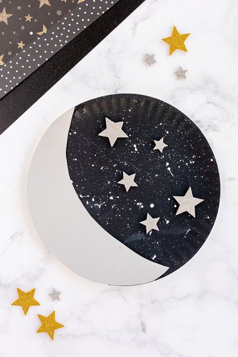 paper plate moon with stars nearby on craft counter Paper Plate Moon Craft, God Made Sun Moon And Stars Craft, Paper Plate Astronaut Helmet, Paper Craft Preschool, Constellation Crafts Preschool, Crescent Crafts Preschool, Sun And Moon Craft Preschool, Moon Craft Ideas, Moon Art Projects For Kids