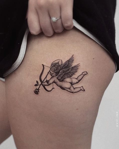 Tattoo of cupid/angel shooting a rose. Black and grey, detailed, fineline, microrealism tattoo. Angel With Roses Tattoo, Baby Cupid Tattoo, Cupid Tattoo Traditional, Angel And Rose Tattoo, Angel Rose Tattoo, Cherub Tattoo Designs, Angle Tattoo, Pair Tattoos, Fox Fire