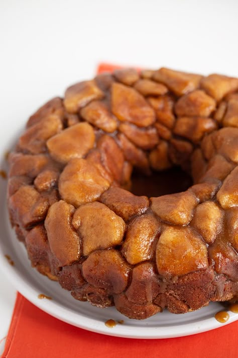 Easy Monkey Bread - This Quick and Easy Monkey Bread is made with biscuits that have been chopped into quarters and rolled in cinnamon and sugar. It’s baked to perfection in a bundt pan and inverted on a plate so the warm gooey brown sugar and butter coat the top and sides of the monkey bread. This quick monkey bread tastes great served warm or at room temperature and will quickly become one of your go-to dessert recipes. It's fun to eat and will save on dirty dishes! #semihomemade #desserts #co Quick Monkey Bread, Cinnamon Bunt Cake, Pillsbury Biscuit Recipes, Biscuit Monkey Bread, Cinnamon Bites, Bundt Pan Recipes, Easy Monkey Bread, Bundt Recipes, Cinnamon Bun Recipe