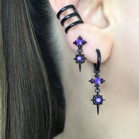 Our Classic Double North Star earrings are now available as a hoop.   Earrings are made of 316 Stainless steel, and set with Black ,Blue and  Purple  CZ. Hoops are perfect for both men and women.   Sold as Pair Total height: 40 mm Hoop Inner diameter: 10.5 mm Post Gauge: 22G (regular piercing) *RETURNS / REFUNDS * -If you would like to return you purchase , please contact us within 7 days of receiving your package and we will accept the return.Return will only be made to the product, and not the shipping cost.  -Buyer is  responsible for the return shipping costs . -All jewelry must be returned unworn and in their original condition . *LOST MAIL* Once the package is marked as DELIVERED by the post office, we are not responsible for misplaced or stolen packages. *MAIL THEFT* If parcel is st Stars Earrings, Star Hoop Earrings, Earrings Gothic, Edgy Jewelry, Jewelry Purple, Earrings Star, Starburst Earrings, Gothic Earrings, Magical Jewelry