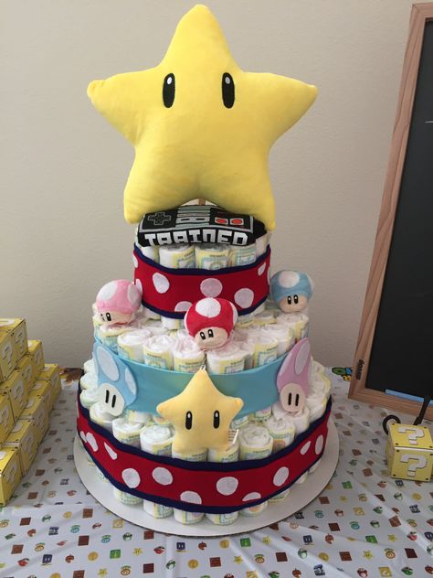 Super Mario themed diaper cake Super Mario Bros Gender Reveal, Mario Baby Shower Ideas, Mario Gender Reveal, Super Mario Gender Reveal, Gamer Baby Shower Ideas, Mario Kart Gender Reveal, Pregnant Super Mario Costume, Gamer Baby, Diaper Cake Centerpieces