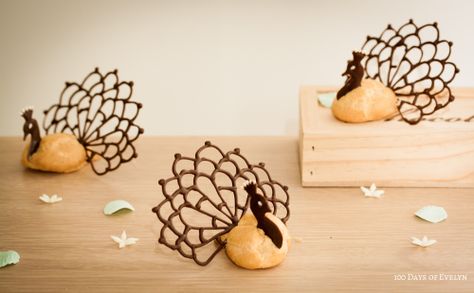 would be adorable done as turkeys for Thanksgiving place settings  |  Peacock Profiteroles Chocolate Puff, Food Tech, Dessert Party, Choux Pastry, Fancy Desserts, Party Buffet, Chocolate Decorations, French Pastries, Plated Desserts