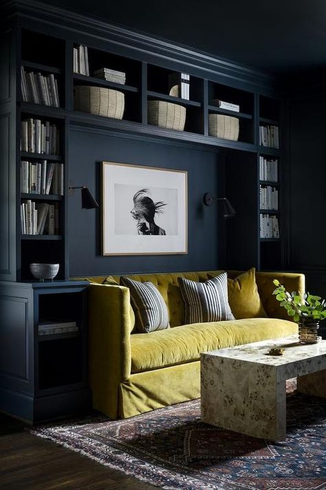 Black built-in bookshelves frame a black and white art piece hung between black sconces and over a citron green velvet tufted shelter back sofa topped with citron green velvet and gray striped pillows. Small Living Room Storage, Room With Bookshelves, Color Drenching, Diy Library, House Buying, Rivers Edge, Paint Trends, Room Update, Living Room Storage