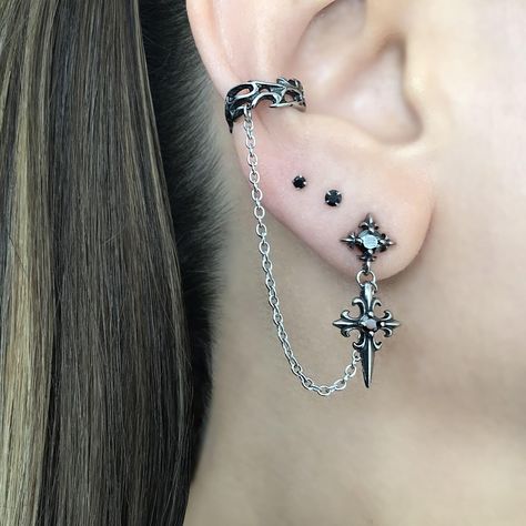 LISTING FOR 1 PIECE ONLY Gothic inspired Cross earring is attached with a chain to the Ear cuff.  Cuff part of the earring needs no piercing, just slide on the ear. This cuff fits both right and left ears.  Material:316 Stainless steel/ set with Black Cubic Zirconia stones Total earring length"  3 1/2"  Cuff :5.5 mm Cross stud:  25 mm *RETURNS / REFUNDS * -If you would like to return you purchase , please contact us within 7 days of receiving your package and we will accept the return.Return wil Gothic Ear Piercings, Silver And Black Earrings, Goth Earrings Aesthetic, Goth Ear Piercings, Gothic Piercings, Alt Earrings, Mens Earring, New Ear Piercing, Ear Piercing Jewelry