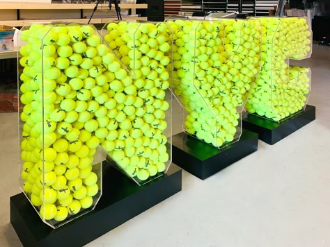 Freestanding NYC 3 dimensional letters full of tennis balls. The letters on this event sign are made of durable acrylic and the base is made of high-quality aluminum. Sports Activation Ideas, Basketball Activation, Tennis Activation, Logo Signage, Ball Display, Sign Boards, Tennis Party, Tennis Event, 3d Signs