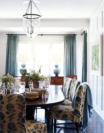 The palest blue in the house is on the dining room walls—Farrow & Ball's Blackened. Chairs are slipcovered in Jasper's Indian Flower in Blue. Antique bell-jar pendant light from Rosemary McCaffrey Antiques; throw from Harnaz Cashmere Collection. Buffet In Front Of Window, Blue Dining Room Walls, Dining Room Blue, Beautiful Spaces, Blue Rooms, Dining Areas, Dining Room Walls, Blue Decor, Slipcovers For Chairs