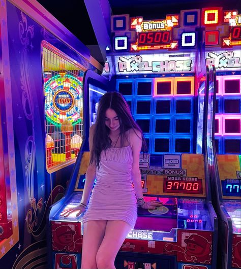 girl in dress looking down sitting on an arcade machine Cassino Pictures, Fun Games