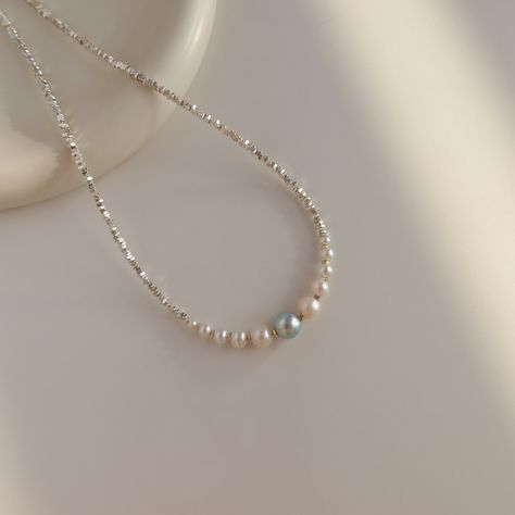 Capture the beauty of the sea with the Monique Necklace. Handcrafted with stunning silver beads, a shimmering blue Akoya pearl and an array of gradual pearls, this necklace is a vision of glimmering elegance. Make a statement with this exquisite necklace that is guaranteed to turn heads! Akoya pearls are treasured for their perfectly round shapes, and reflective shine. Akoya pearls are usually white or pink. Occasionally, they are blue with silver and pink overtones, but it is so rare that only Elegant Beads Necklace, Pink Beaded Necklace, Vday Gifts, Bracelets Diy, Eyeglass Chain, Jewelry Beads, Beaded Bracelets Diy, Akoya Pearls, Stylish Jewelry