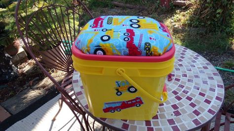 I got a cat little bucket from the recycling at my son's house. I planned to make a little storage stool and holder for some books and little toys for my 2 and a half year old great grandson. We are hoping he and his parents will visit the end of Aug.   I washed and dried the Tidy cat bucket   I then painted it with some great spray paint that is great for painting plastic   I then cut some left over Mattress cover which I had left over from another project.   This is the little cover… Cat Liter, Rusty Bed Springs, Recycle Projects, 4h Projects, Pool Storage, Bucket Ideas, Tidy Cats, Diy Stool, Vintage Milk Can