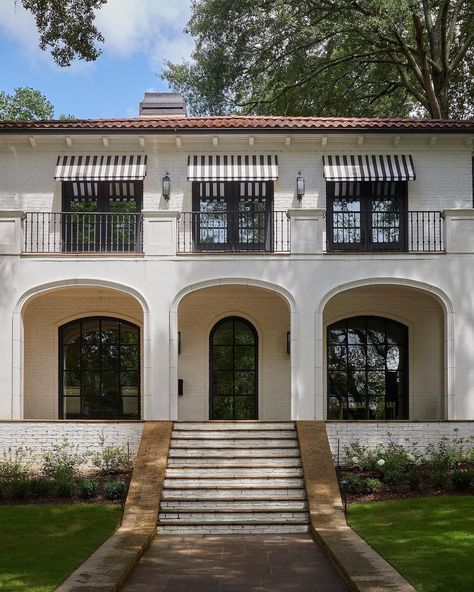 Columns and balconies in Mediterranean-style homes are often adorned with intricate wrought iron designs, adding a touch of elegance and charm to the overall aesthetic. These architectural features provide the perfect spot for residents to enjoy the stunning views and gentle breezes of the Mediterranean climate. Columns and balconies from @buckheadbecky White Mediterranean House Exterior, Mediterranean House Exterior Modern, House In Suburbs, White Mediterranean House, Brick Balcony, House Design Coastal, Contemporary Mediterranean House, Wrought Iron Designs, Mediterranean House Design