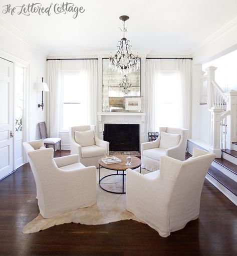 Neutral Living Room | White | Slipcovers | Cowhide Rug | Wall Sconces | Fireplace | Round Coffee Table | Ashley Gilbreath Interiors Ashley Gilbreath Interiors, Salons Cottage, Living Room Arrangements, Hearth Room, Cottage Living Rooms, Neutral Living Room, Living Room Remodel, Living Room White, Family Room Design