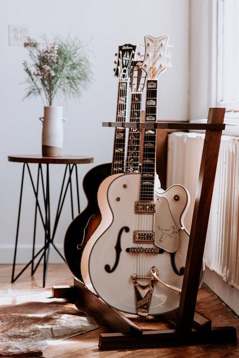 Our bench-made Olin Guitar Stand is the perfect alternative to the mass-production multi-guitar stands available today. Utilizing American hardwoods and traditional joinery, this stand allows you to keep your instruments at hand without sacrificing design. Graceful in proportion, the Olin combines modern design with a functional display that’s safe for all stringed instruments, making it ... Office Music Room Ideas, Instrument Organization, Guitar Display Ideas, Funky Music Room, Guitar Room Aesthetic, Guitar Stand Ideas, Multi Guitar Stand, Guitar Corner, Multiple Guitar Stand