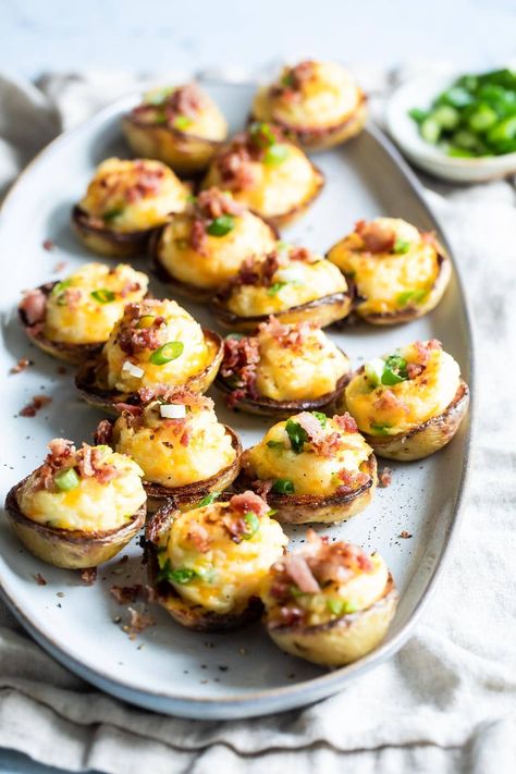 Mini Twice Baked Potatoes are like appetizer-sized potato skins with the volume turned up. Although this party snack recipe tastes like it took all day, these bacon-studded beauties can be yours in just 35 minutes. Mini Twice Baked Potatoes, Baked Potato Skins, Potatoe Skins Recipe, Potato Appetizers, Mini Potatoes, Bite Size Food, Bacon Fries, Party Snack Food, Twice Baked