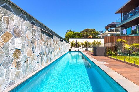 Pool Against Fence, Pool With Wall On One Side, Pool With Stone Wall, Pool Against Wall, Commercial Landscape Design, Stone Pool, Stone Wall Cladding, Pool Remodel, Natural Stone Wall