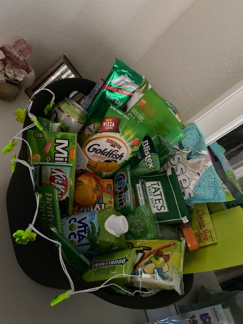 Using all green items in the basket for March birthday Green Color Baskets Gift Ideas, Green Items For Gift Basket, Green Birthday Box Ideas For Best Friend, Color Party Basket Ideas Green, Dark Green Gift Basket, Green Gift Basket Ideas For Him, Color Party Green Snacks, Green Color Party Basket, Green Birthday Box Ideas