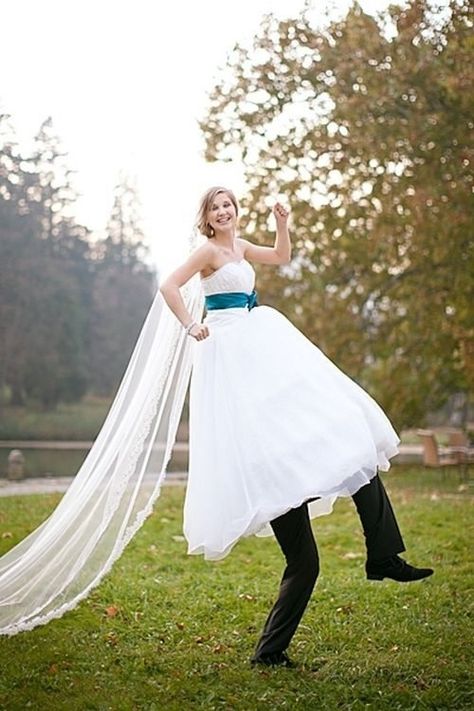 Something a little silly, if you don’t mind the groom having his head up your skirt. | 42 Impossibly Fun Wedding Photo Ideas You'll Want To Steal Veil, A Woman, White Dress, White, Black