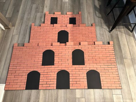 Making Bowser’s Castle – Part 2 – Florida Life with Laura Bowser Castle Background, Diy Mario Castle Cardboard, Diy Super Mario Backdrop, Diy Bowsers Castle, Super Mario Castle Diy, Mario Pipe Diy, Bowser Trunk Or Treat Ideas, Mario Castle Diy, Bowsers Castle Diy