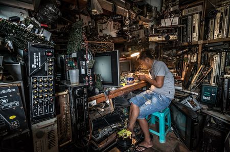 Electronics Repair Shop Photo by Huynh Jet — National Geographic Your Shot Electronic Repair Shop, Repair Shop Aesthetic, Cyberpunk Workshop, Writing Desk Aesthetic, Cinematic Photography Portraits, Small Room Inspo, Industrial Hallway, Cyberpunk Room, Computer Repair Shop