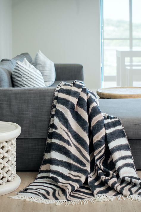 The elegant way to embrace animal print - our Zebra print throw brings an irreverent element, and a layer of warmth to your space. 🦓 Zebra Print Throw Blanket, Zebra Throw Blanket, Ways To Cuddle, African Interior Design, African Interior, Jungle Cruise, Africa Animals, African People, Blanket Wrap