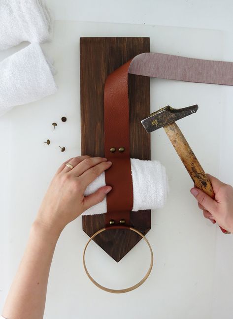 This easy to build  DIY towel storage holder is a really great space saver for small bathrooms. #storageideas #bathroom #smallspaceliving #diyideas Diy Wood And Leather Projects, Leather Strap Towel Holder, Towel Hanger Ideas Bathroom Diy, Leather Home Decor Diy, Leather Towel Holder, Hand Towel Holder Ideas Diy, Diy Towel Storage, Leather Home Accessories, Towel Hanger Diy