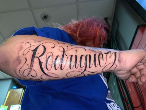 Rodriguez tattooed on right forearm Rodriguez Tattoo Name On Arm, Sanchez Tattoo Last Name, Forearm Tattoo Women Names, Forearm Name Tattoo Women, Lopez Tattoo Last Name, Forearm Name Tattoos For Women, Arm Name Tattoos For Women, Name Tattoo On Forearm, Rodriguez Tattoo Name