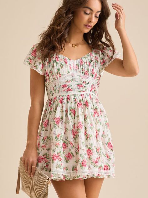 This charming mini dress features playful puff sleeves, a flattering shirred bodice, and delicate ruffled trim, all perfectly complementing the vibrant floral print. Its flirty silhouette and comfortable design make it ideal for everything from sunny picnics to evening garden parties. Evening Garden, Garden Parties, Altar'd State, Floral Mini Dress, Puff Sleeves, Garden Party, Puff Sleeve, Bodice, Floral Print