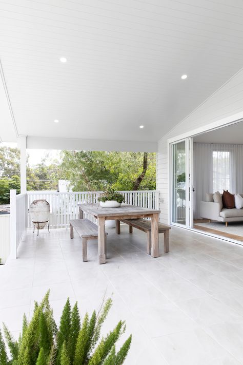 Indoor outdoor living at the Kedron Street house - Style Curator Sliding Doors Back Of House, Outdoor Dining Table Bench Seat, Indoor To Outdoor Living, White Decking Ideas, Outdoor Tiling Ideas Patio, White Sliding Doors Exterior, White Deck Ideas, Outdoor Alfresco Ideas, Outdoor Sliding Doors