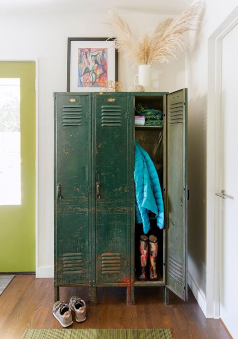 Blues, greens and warm dollops of orange ripple through the home—in art, textiles and even on the mudroom door, painted in Benjamin Moore's Dark Celery. Mudroom Door, Entry Way Lockers, Mudroom Inspiration, Ranch Renovation, Sleek Fireplace, Vintage Lockers, Midwest Living, Art Textiles, Ideas For Decorating