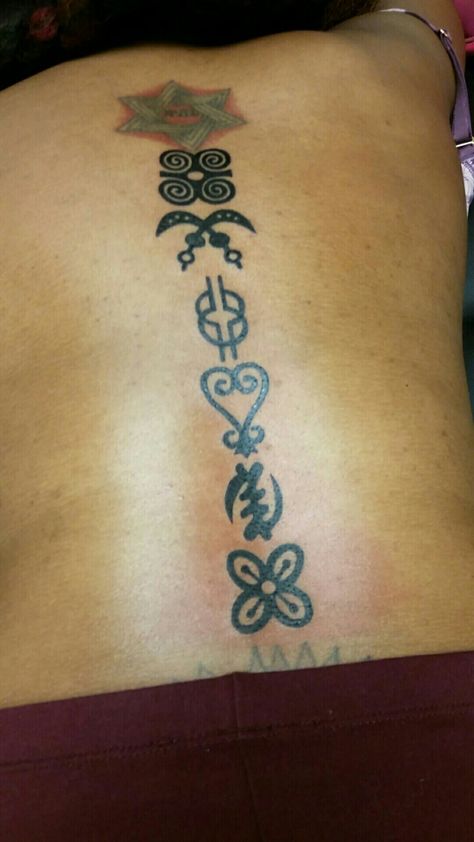 African Adinkra symbols. Spine tattoo African Symbol Tattoo Woman, Ghanian Tattoo Ideas, Adrinka Symbols Tattoo Creative Design, Adinkra Tattoos For Women, Symbols Spine Tattoo, Adinkra Symbols Tattoos, African Symbol Tattoo, Ghana Tattoo, African Inspired Tattoos