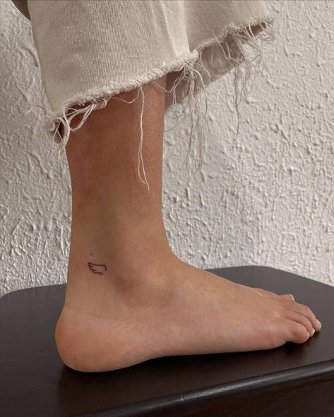 Feet Minimalist Tattoo, Minimal Ankle Tattoos For Women, Minimalist Tattoo Angel Wings, Small Ankle Tattoo Placement, Minimal Tattoo Ankle, Angel Wings On Ankle, Angel Wing Tattoo Fine Line, Leg Tattoos Minimalist, Ankle Tattoo Fine Line