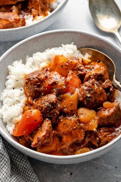 A treasured family recipe for authentic Hawaiian Beef Stew! A tangy & rich tomato gravy simmers with onions, carrots, potatoes, & beef until fall-apart tender. Serve it over rice for a true taste of the islands. Hawaiian-style beef stew is traditional Hawaiian comfort food, & it couldn't be easier to make! Stovetop, oven, slow cooker & Instant Pot directions provided. #hawaiianrecipes #traditionalhawaiianrecipes #authentichawaiianrecipes #hawaiianbeefstew #beefstew #comfortfood