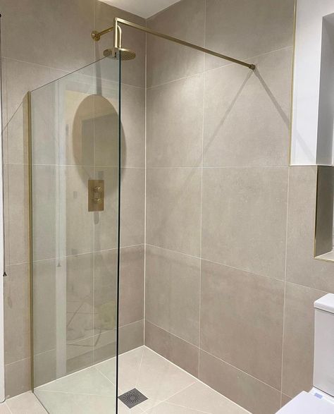 Our Vista Brushed Brass wet room screen glows in this stunning showering space from @athomewithholli 😍 The golden hues of the screen are beautifully coordinated with Hoxton Brushed Brass shower brassware from @brittonbathrooms, set to a relaxing neutral backdrop #brushedbrass #brassbathrooms #goldbathroom #wetroom #modernbathroom #bathroomtransformation #homedecor #homeinteriors #bathroominspiration #goldtaps #renovation #bathroomdesign #bathroominspo #bathroomofinsta #bath #bathroom Neutral Gold Bathroom, Taupe Master Bath, Neutral Shower Tile, Bathroom Taupe, Neutral Master Bath, Small Beige Bathroom Ideas, Brushed Brass Shower, Warm Tiles, Taupe Bathroom