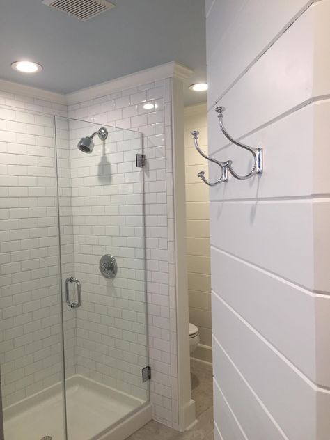 Tongue and groove wall with Pottery Barn robe hooks; and the subway tiled shower with frameless glass enclosure. Notice the pale blue ceiling, which connects this master bath to the master bedroom color, and lovely white crown molding. Shower Crown Molding, Shower With Crown Molding, Crown Molding Bathroom Ceilings, Shower Tile To Ceiling Crown Molding, Crown Molding In Bathroom, Ceiling Shower Head Master Bath, Crown Molding In Bathroom With Tile, Bathroom Crown Molding, Bathroom Molding