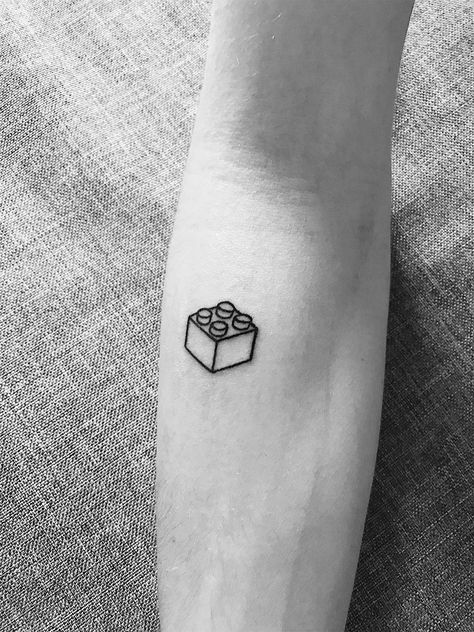 Lego brick tattoo Simple Lego Tattoo, Minecraft Tattoo Minimalist, Lego Tattoo Ideas For Men, Lego Piece Tattoo, Lego Block Tattoo, Lego Head Tattoo, Lego Man Tattoo, Lego Brick Tattoo, Lego Tattoo Ideas