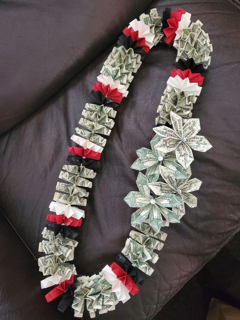 This is a $50 money lei with 4 flower cluster. Includes $38 in $1 bills on lei with an additional $12 in $1 bills on the flowers. You can choose the color of the paper, up to 3 colors. Perfect for graduations, birthdays, anniversaries or weddings. Check us out on Instgram for more designs. Money Lanyard Graduation, Money Lei For Men, Candy Leis Diy, Money Garland Graduation, Money Leis For Graduation Diy Tutorial, Money Necklace For Graduation, How To Make Money Leis For Graduation, Money Leis For Graduation Diy, Graduation Lei Ideas