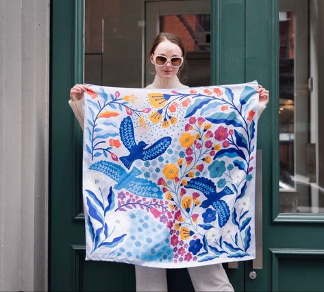 A woman holding up a silk scarf outside. Print Scarf Design, Silk Scarf Design, New York Design, Luxury Scarf, Hand Painted Scarves, Painted Scarf, Bandana Design, Art Scarves, Silk Scarf Painting