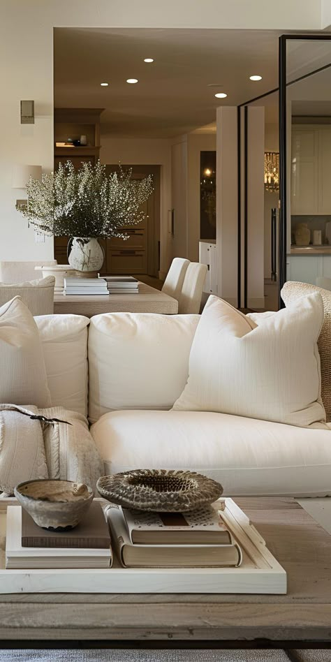 Elegant furnishings fill the living room, embodying timeless design and aesthetic balance. Timeless Living Room Interior Design, Neutral Color Palettes, Timeless Living Room, Flat Decor, Beige Living Rooms, Warm Interior, Condo Decorating, Modern Farmhouse Design, White Living Room