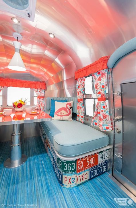 TimelessTravelTrailers-60sRetroAirbnb-2 Kitchen With Terrazzo, Retro Airstream, Terrazzo Countertops, Small Travel Trailer Remodel, Blue Flooring, Small Travel Trailer, Dining Booth, Patterned Curtains, Small Travel Trailers