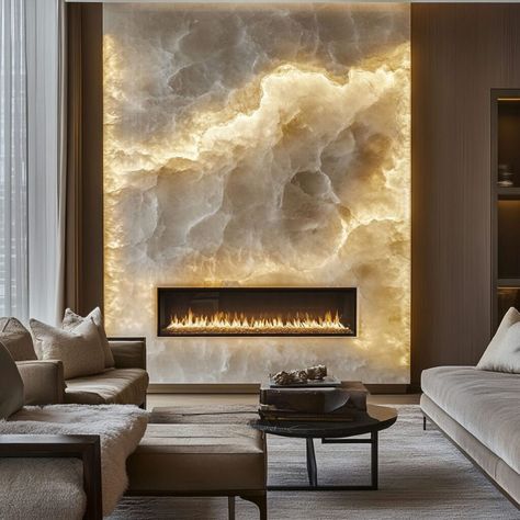 Enhance your space with this breathtaking backlit quartz fireplace wall, creating a glowing, luxurious ambiance in any modern interior. The quartz material building technique emphasizes durability and natural elegance, making it a perfect choice for contemporary homes. This striking feature combines warm lighting with the textured beauty of quartz, adding both sophistication and warmth, ideal for those seeking high-end, transformative home decor ideas. Modern Contemporary Fireplace Ideas, High Wall Fireplace Ideas, Fireplace Texture Ideas, Backlit Stone Wall, Backlit Fireplace, Textured Fireplace Wall, Epoxy Fireplace, Quartz Fireplace Wall, Stone Feature Wall Living Room