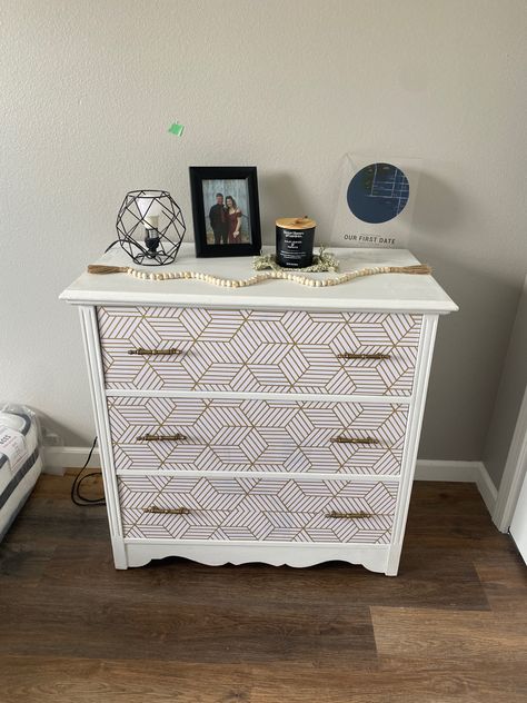 I took an old white dresser and turned it into this with only a few simple steps. 1. Simple white paint over top and sides. 2. Wallpaper over dresser drawers #wallpaper #dresser #diy #makeover Drawers Wallpaper, Wallpaper On Dresser, Dresser Diy Makeover, Wallpaper Dresser, Diy Upcycled Decor, Gold Geometric Wallpaper, Dresser Diy, Upcycled Decor, Nice Wallpaper