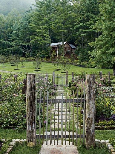 There are also some guest cottages on the property of "Toad Hall." Per Suzanne Kasler, this two-room Tadpole Cottage was “built from a simple sketch. The builder just put it together.” She adds that two words that embody the property are “charm and folly!” Rustic Backyard, Gates And Fences, English Country Style, Gardening Books, Farm Style, Garden Gate, Cabin In The Woods, Garden Cottage, Rustic Gardens