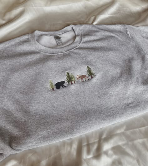 "Embroidered Bear and Moose Sweatshirt -Embroidered on a cotton/polyester blend crewneck sweatshirt, this design is simple and minimalistic, perfect for every outfit! -Embroidery design measures 1.25\" x 5\". -See product pictures for shirt sizing chart. **SWEATSHIRTS ARE IN UNISEX SIZING AND RUN TRUE TO SIZE. -All sweatshirts are handmade on an embroidery machine so there may be slight differences, but we only sell the sweatshirts that meet our high-quality standards. -To maintain the quality o Grey Sweatshirt Embroidery, Cute Sweatshirt Embroidery Ideas, Cute Embroidered Shirts, Machine Embroidered Clothes, Cute Embroidery Ideas Shirts, Machine Embroidery Tshirt, Embroidery Designs For Shirts, Embroidery Designs Sweatshirt, Moose Embroidery