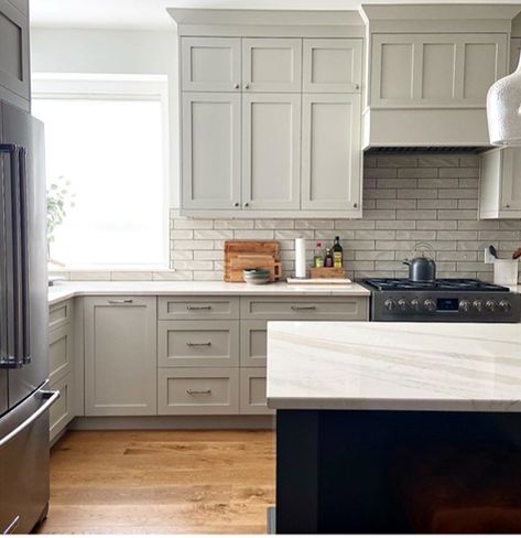 Learn all about the undertones and LRV of Benjamin Moore Revere Pewter. Shown here slightly darkened on painted maple cabinets, white oak flooring, warm gray subway tile backsplash and Cambria Brittanica Warm white quartz countertop. Kylie M Interiors Edesign  #quartzcountertop #reverepewter #benjaminmoore #graycabinets #paintedcabinets #subwaytile #graykitchen #whiteoak #edesign #kylieminteriors #kyliemedesign #colourconsultant #bestpaintcolours Revere Pewter Cabinets, Pewter Cabinets, Revere Pewter Kitchen, Moore Kitchen, Kylie M Interiors, Revere Pewter Benjamin Moore, Kitchen Cabinet Inspiration, Reliable Sources, Cabinet Paint Colors