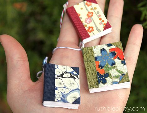 Tiny books to use to make napkin rings or what? Handful of handmade book Christmas tree ornaments by Ruth Bleakley Miniature Book Ornaments, Diy Book Ornaments Craft Ideas, Tiny Book Ornament Diy, Book Themed Ornaments Diy, Diy Mini Book Ornament, Book Themed Ornaments, Diy Mini Christmas Tree Ornaments, Book Theme Christmas Tree, Mini Book Ornaments Diy