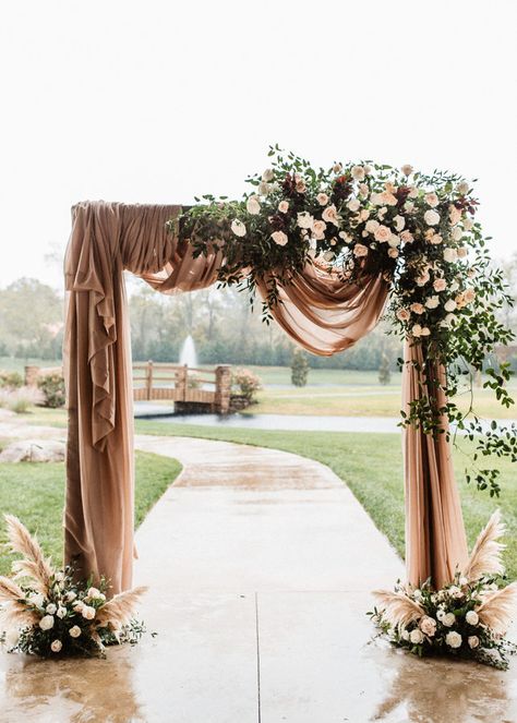 A pink draped outdoor ceremony backdrop with florals surrounding with pops of pink, red, green, and some pampas grass. Draped Backdrop, Place For Wedding, Engagement Stage, Reception Styling, Reception Stage Decor, Outdoor Backdrops, Boho Backdrop, Entry Gate, Plus Wedding Dresses