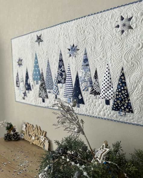 The best thing about this horizontal quilted wall hanging is that it can be used not just for Christmas, but throughout the winter. This quilt is made using appliqué and free-motion fantasy quilting techniques that imitates the dance of wind and snowflakes in the winter sky. This quilting is my pride. I have been improving it for many years. It is not a computer stitch, I create it with my own hands on a household sewing machine. This quilt is unique.
Size is 24х46". Winter Quilts Patterns, Christmas Quilted Table Runner, Christmas Tree Wall Hanging, Sky Quilt, Applique Wall Hanging, Blue Trees, Christmas Quilt Blocks, Xmas Home Decor, Winter Quilt