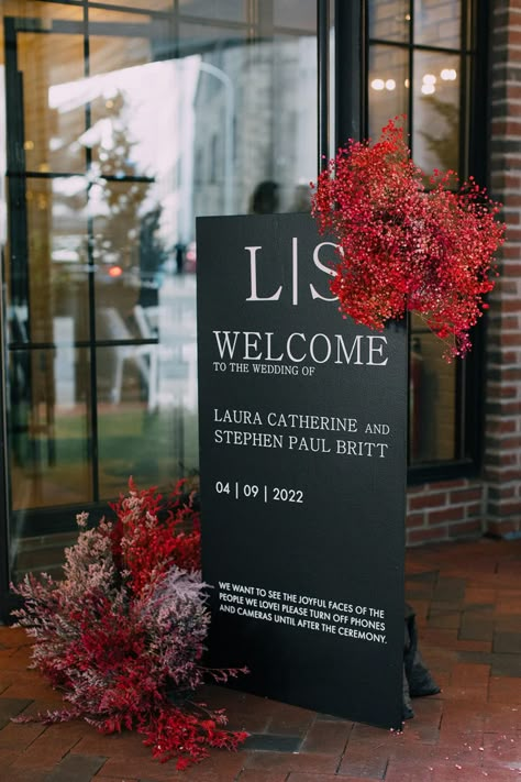 Black and white signage for the couple’s wedding at the Fitler club with modern red floral accents. Red Black And White Event Decor, Black White And Dark Red Wedding, Black And Red Wedding Party, Red Black And White Engagement Party, Black White Red Wedding Theme, Red And Black Wedding Decor, Black Wedding Signage, Red Centerpieces Wedding, Black White And Red Party