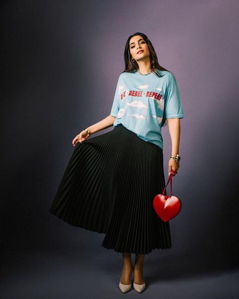 Sonam Kapoor Ahuja embraces a playful elegance with a touch of personal flair Red Checkered Shirt Outfit, Checkered Shirt Outfit, Anand Ahuja, Sonam Kapoor Fashion, Red Checkered Shirt, Black Pleated Midi Skirt, White Pump, Monochromatic Outfit, French Girl Style