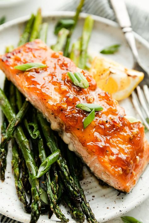 This flavorful Sheet Pan Honey Glazed Salmon with Asparagus is a healthful dinner that’s sure to join your arsenal of go-to dinner recipes. Bright and tender salmon fillets get coated with a sweet honey glaze and combined with crispy asparagus on a single baking sheet. With a cook time of just 12 minutes, the total time to make this well-rounded dinner is less than 30 minutes. Paleo Canned Salmon Recipes, Sheet Pan Honey Mustard Salmon, Honey Glazed Salmon Pan Seared, Honey Salmon In Foil Damn Delicious, Dietician Recipes, Salmon Asparagus Sheet Pan, Crispy Asparagus, Seafood Cuisine, Honey Glazed Salmon Recipe